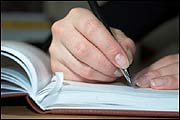 Photo: writing in a book (Petro Feketa/iStockphoto)