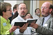 Grier Novinger, Ted Jones, and the Rev. Chris Buice sing together (Karen Krogh)