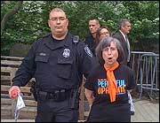 Joan Gregory, environmental ministry coordinator at First Unitarian Church of Salt Lake City, was led away in handcuffs after protesting federal energy policy.