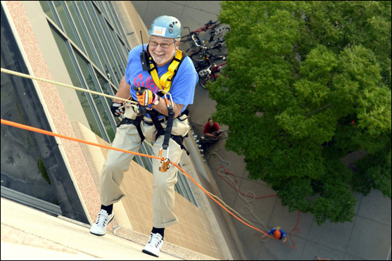 UUA President Peter Morales rappels down the Rhode Island Convention Center as part of the UUA's Brave Souls: UUs Pledge Over the Edge fundraiser.   ©Nancy Pierce/UUA. All rights reserved.