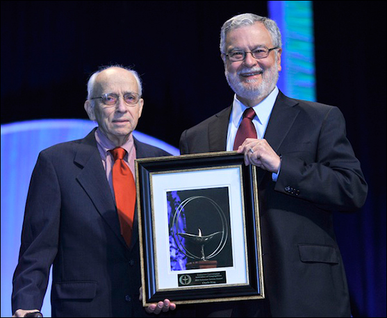 Charlie King receives the Volunteer Service Award from Peter Morales.