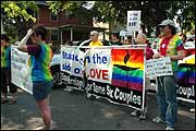 Church members carry torn sign in Rochester gay pride parade
