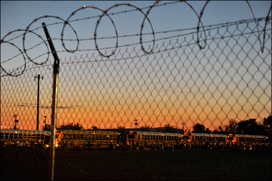 Buses arrive at the 'Tent City' jail.
