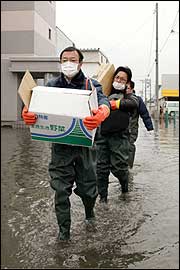 A relief team carries emergency supplies to disaster victims