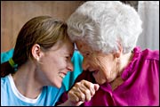 elderly woman laughs with young woman (Mark Papas/iStockphoto)