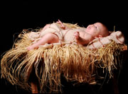 Baby in a manger (©Dayna More/Bigstock.com)