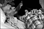 Man in hospice, with child (Damon Brandt)